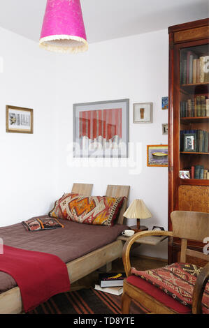 Old style bed with patterned pillows in bedroom   UK & IRISH USE ONLY Stock Photo