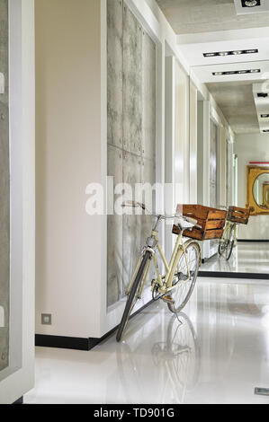 Vintage bike with old wooden box in modern hallway   UK AND IRISH RIGHTS ONLY Stock Photo