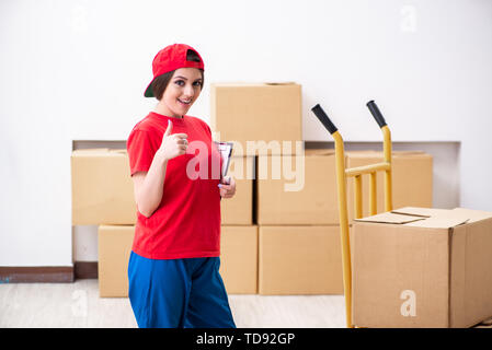 Young female professional mover doing home relocation Stock Photo