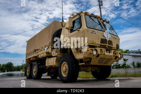 U.S. Soldiers with the 835th Combat Sustainment Support Battalion, Missouri Army National Guard, use a 5-ton Medium Tactical Vehicle to patrol around the flooded Jefferson City Memorial Airport, during flood relief efforts in Jefferson City, Mo., June 6, 2019. The Missouri National Guard was activated to support flood relief efforts when Gov. Mike Parson declared a state of emergency due to flooding of the Missouri River. (U.S. Air National Guard photo by Senior Airman Audrey Chappell) Stock Photo