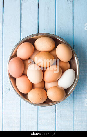 Raw chicken eggs in bowl. Top view. Stock Photo