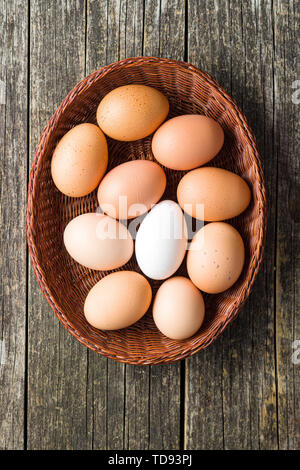Raw chicken eggs in basket. Top view. Stock Photo