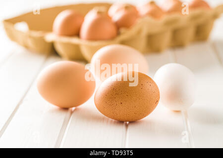 Raw chicken eggs on white table. Stock Photo