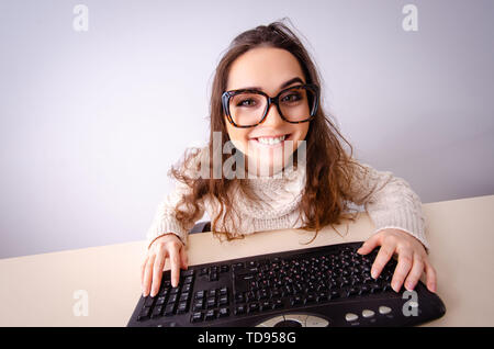 Funny nerd girl working on computer Stock Photo