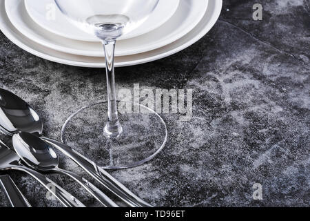 Knives, forks, spoons and empty glass glasses and plates on the table Stock Photo