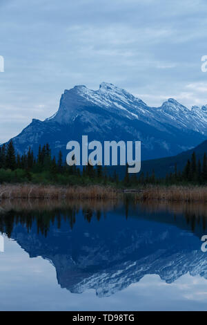 Mt Rundle Snow Snow-covered Mount Rundle mountain range with snowy forest over blue ...