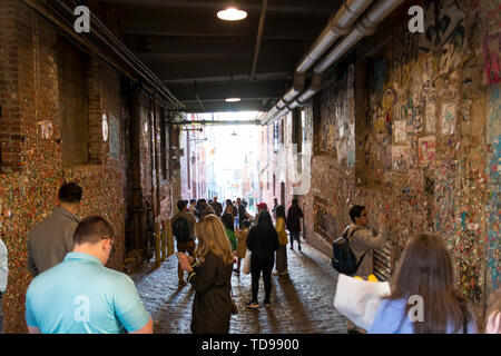 Seattle, Washington, USA / March 2019: People at the Market Theater Gum Wall in downtown Seattle - a local landmark in downtown Seattle in Post Alley  Stock Photo