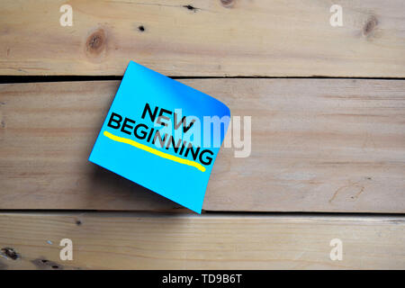 New Beginning text on sticky notes with wooden background Stock Photo