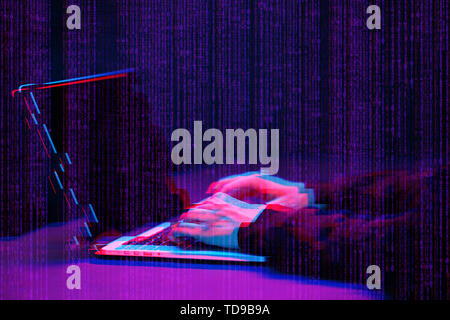 Hacker working with laptop in dark room with digital interface around. Image with glitch effect. Stock Photo