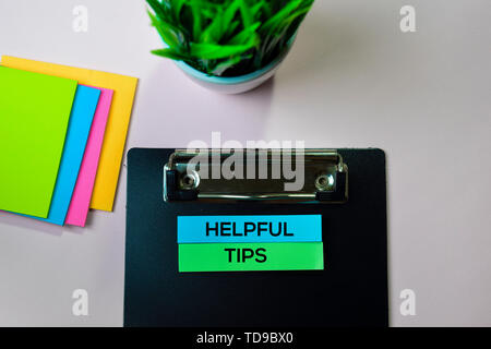 Helpful Tips text on sticky notes with office desk concept Stock Photo