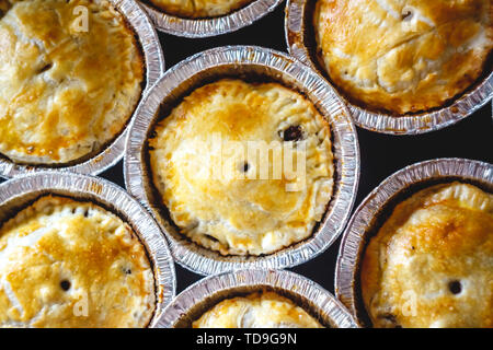 closed mini-quiche quiche stuffed with meat and mushrooms, fruits, cherries on a dark background. top view. Stock Photo