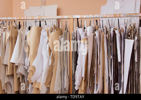 Patterns for sewing hang on the wall. many embroidery crown. industrial production of clothing, a large number of paper sewing designs Stock Photo