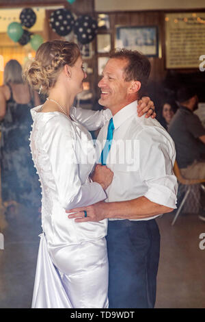 Bride & groom dancing in artificial smoke at their wedding reception;  Congressional Church; Buena Vista; Colorado; USA Stock Photo