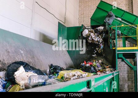 Sort garbage on the plant. Waste at the first stage of processing. The process of separating garbage in a container. Automated line in the emergency Stock Photo