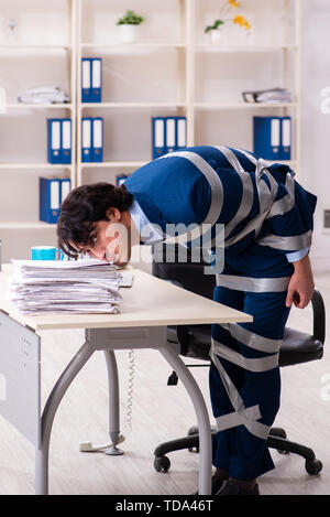 Young tied male employee in the office Stock Photo