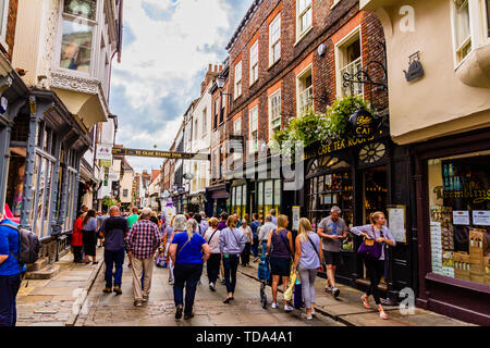 Shoppers and tourists on Stonegate, a famous pedestrianised street near York Minster.York, Yorkshire, UK. August 2018. Stock Photo