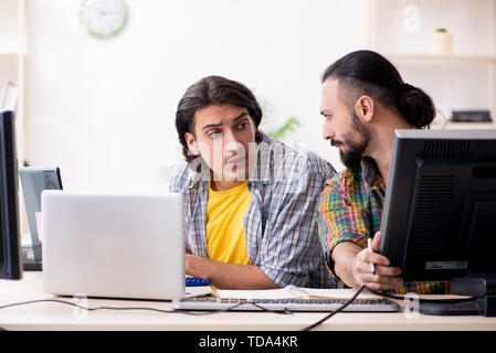 Two it specialists working in the office Stock Photo
