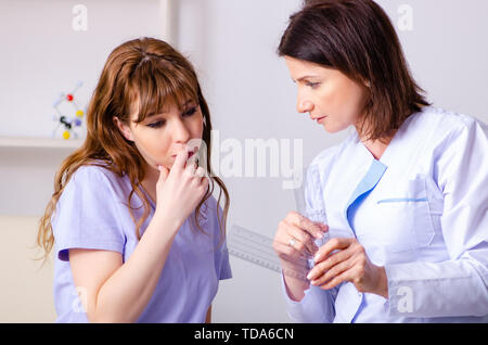 Female doctor checking patient's joint flexibility with goniometer Stock Photo