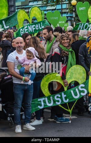 London, UK. 14th June 2019. People gather to walk in silence from close to Grenfell Tower remembering the victims of the disaster on the second anniversary of the disastrous fire which killed 72 and left survivors traumatised. Promises made by Theresa May and Kensington & Chelsea council have not been kept and the enquiry seems to be simply providing an excuse for inaction. Credit: Peter Marshall/Alamy Live News Stock Photo