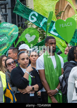 London, UK. 14th June 2019. People gather to walk in silence from close to Grenfell Tower remembering the victims of the disaster on the second anniversary of the disastrous fire which killed 72 and left survivors traumatised. Promises made by Theresa May and Kensington & Chelsea council have not been kept and the enquiry seems to be simply providing an excuse for inaction. Credit: Peter Marshall/Alamy Live News Stock Photo