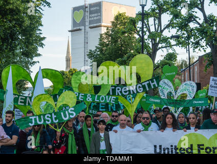 London, UK. 14th June 2019. Thousands walk in silence from close to Grenfell Tower remembering the victims of the disaster on the second anniversary of the disastrous fire which killed 72 and left survivors traumatised. Promises made by Theresa May and Kensington & Chelsea council have not been kept and the enquiry seems to be simply providing an excuse for inaction. Credit: Peter Marshall/Alamy Live News Stock Photo