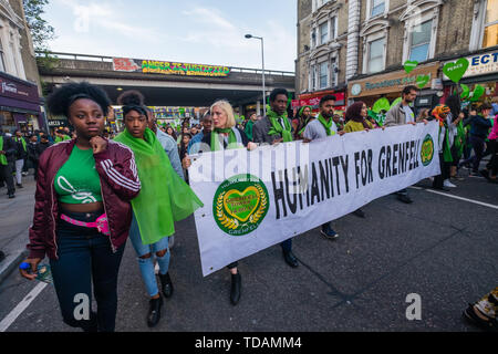 London, UK. 14th June 2019. Humanity for Grenfell walk in silence from close to Grenfell Tower remembering the victims of the disaster on the second anniversary of the disastrous fire which killed 72 and left survivors traumatised. Promises made by Theresa May and Kensington & Chelsea council have not been kept and the enquiry seems to be simply providing an excuse for inaction. Credit: Peter Marshall/Alamy Live News Stock Photo