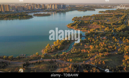 The aerial shot was taken at Bian West Lake and Zheng Kai Avenue and Bian West Lake Silver Beach in Kaifeng City, Henan Province on October 27, 2018. It shows the urban strategy of Kaifeng City to moisturize the city with water and the rapid changes of Bian West New District. Stock Photo