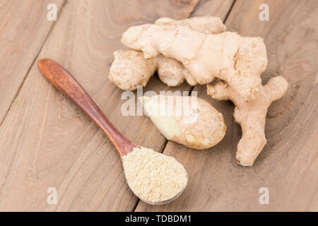 Ginger powder and ginger on wooden table Stock Photo