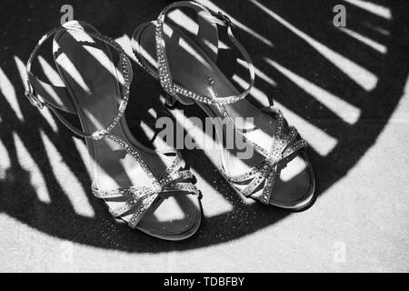 Luxurious sandals with precious stones for the bride, lying on the carpet Stock Photo