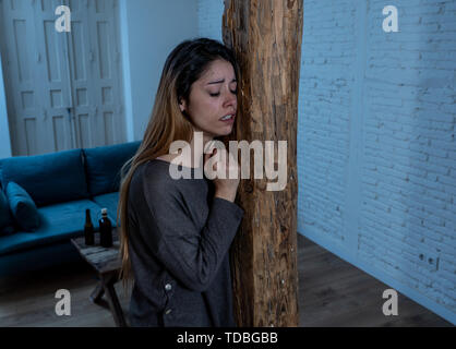 Social issues Domestic violence concept. Woman victim of spouse intimate abuse and physical aggression feeling hopeless and scared crying in distress  Stock Photo