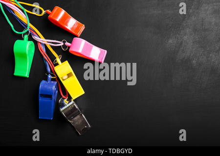 Whistle on blackboard background
