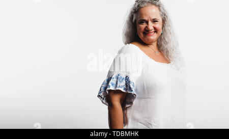 Smiling old woman in white hair isolated on a white background. Senior woman with a beautiful smile looking at camera. Stock Photo