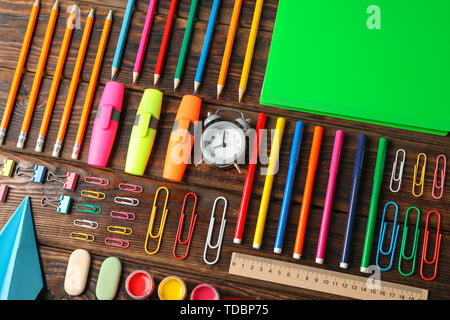 School supplies flat lay on wood background, top view. Back to