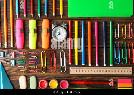 Flat lay composition with school supplies on wooden background Stock Photo