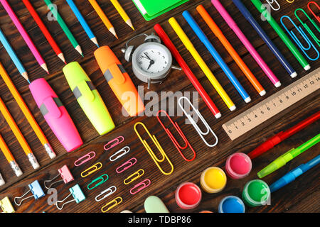Flat lay composition with school supplies on wooden background Stock Photo