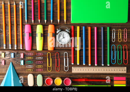 Flat lay composition with school supplies on wooden background Stock Photo