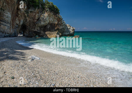 Milopotamos beach in Greece. Rocky cliffs and clear turquoise sea. Beautiful day in June Stock Photo