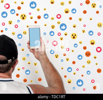 Man hold phone in hand, photography Likes in social networks Stock Photo