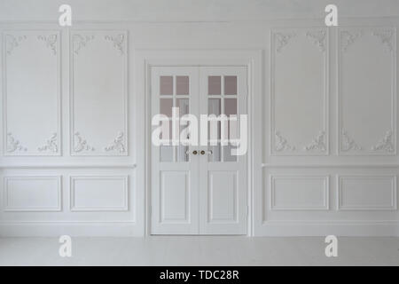 Luxurious bright interior of the living room in Baroque style with stucco and double door. Stock Photo