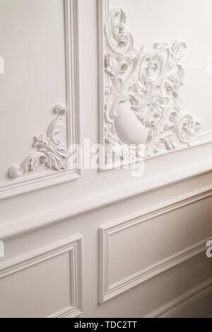 Stucco elements on light luxury wall. White patterned. Roccoco style. Close up. Selective focus. Stock Photo