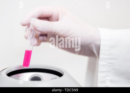 Close up Scientist Putting Test Tube Into Centrifuge .  Stock Photo