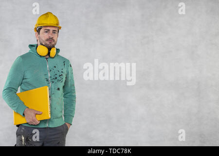 modern building supervisor keeps the computer in his hands, technology at work Stock Photo