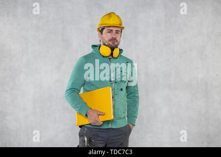 modern building supervisor keeps the computer in his hands, technology at work Stock Photo