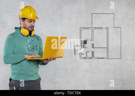modern building supervisor keeps the computer in his hands, technology at work Stock Photo