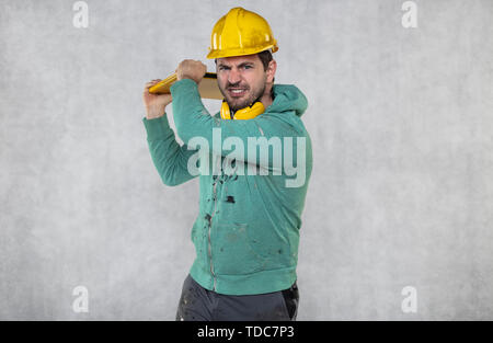 modern building supervisor keeps the computer in his hands, technology at work Stock Photo