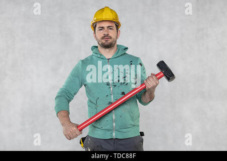 construction worker with a hammer in hand, concept of construction and disassembly, renovation Stock Photo