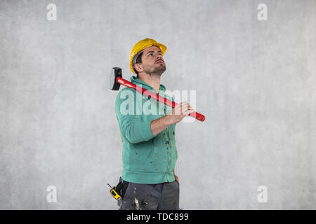 construction worker with a hammer in hand, concept of construction and disassembly, renovation Stock Photo
