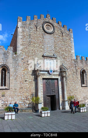 Taormina, Sicily, Italy - Apr 8th 2019: Tourists in front of beautiful St. Nicholas Church, known also as Duomo di Taormina on a sunny day with blue Stock Photo