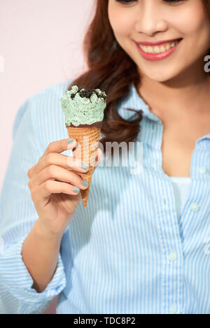 Sweet happy moments of attractive fashionable young woman having fun with cone ice cream on pink background. Dreaming, delicious, enjoying, happiness, Stock Photo
