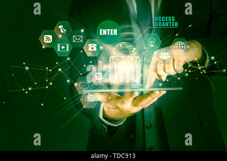 Businessman holding tablet with hologram of the concept of data protection, access granted. Man secures personal information on tablet Stock Photo